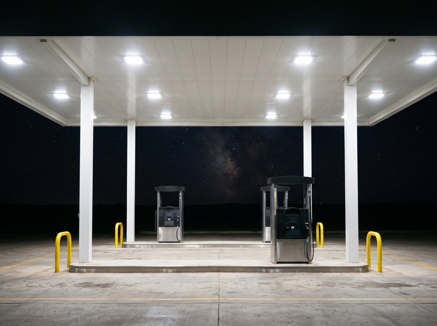 LED canopy fixtures lighting a fuel island at night